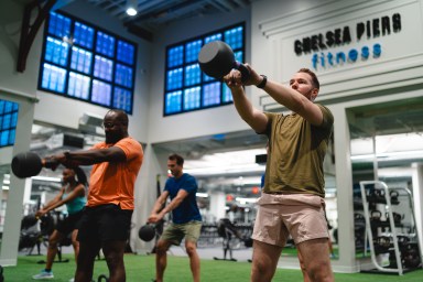 members swinging kettlebells at Chelsea Piers Fitness