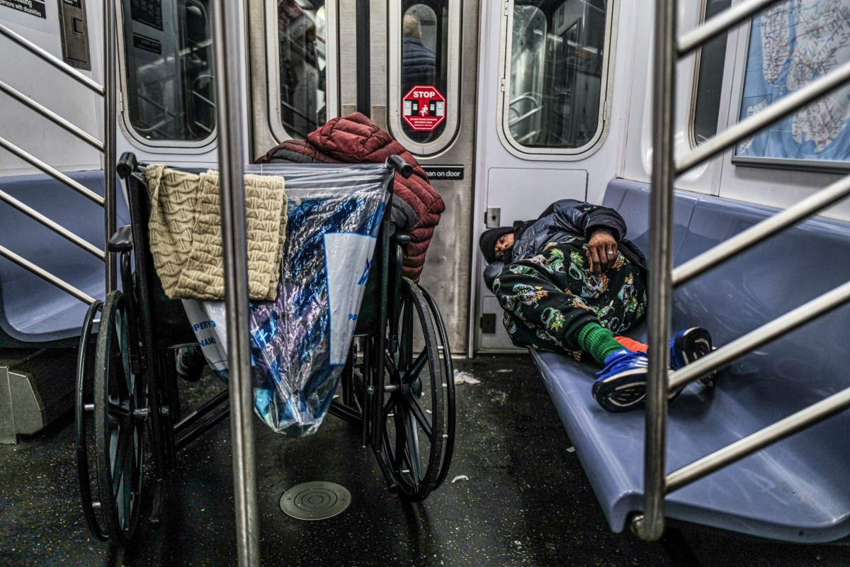 Homeless individuals sleeping on a subway train in New York on Jan. 13, 2025.