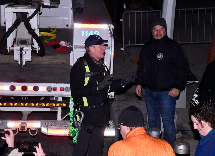 MTA workers on a NYC street at night