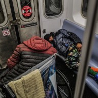 Homeless individuals sleeping on a subway train in New York on Jan. 13, 2025.