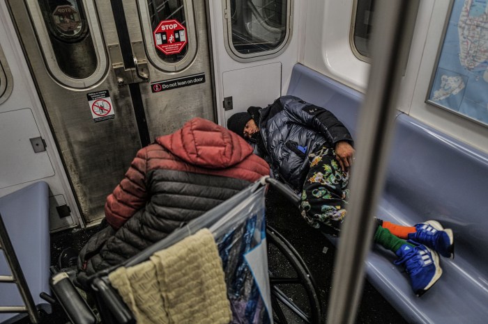 Homeless individuals sleeping on a subway train in New York on Jan. 13, 2025.