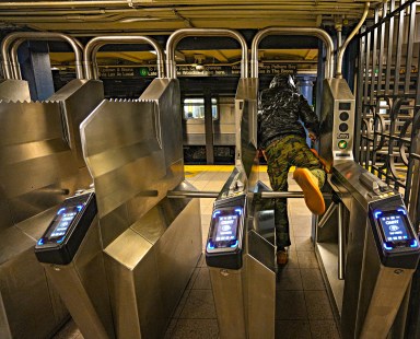 fare evaders jumping turnstile in a NYC subway