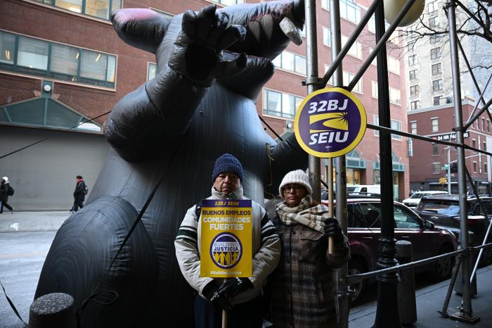 Nelson Employees poses in front of scabby rat over alleged unfair labor practices at the Con Edison building.