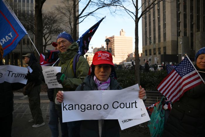 The unwavering fans stood proud with MAGA apparel, flags brandishing Trumps face and signs pointing towards his alleged innocence as news of the judge's decision spread. 