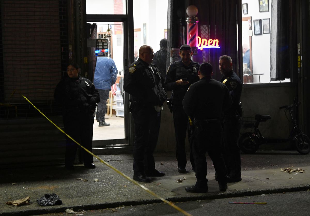 Officers from Brooklyn's 75th Precinct investigate their first shooting of 2025 on Wednesday night, Jan. 1, that left a man wounded in a barber shop on Stanley Avenue in East New York.