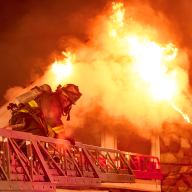 Firefighter approaching flames in Brooklyn three-alarm fire