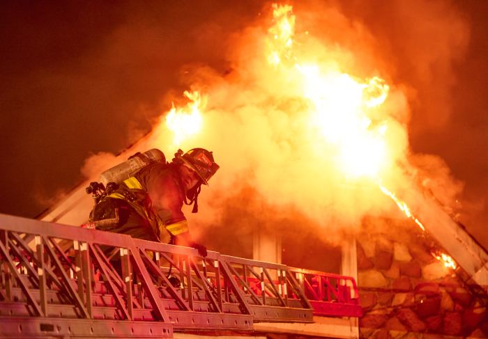 Firefighter approaching flames in Brooklyn three-alarm fire