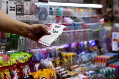 Man holding New York Lotto ticket