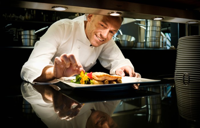 Chef garnishing a meal