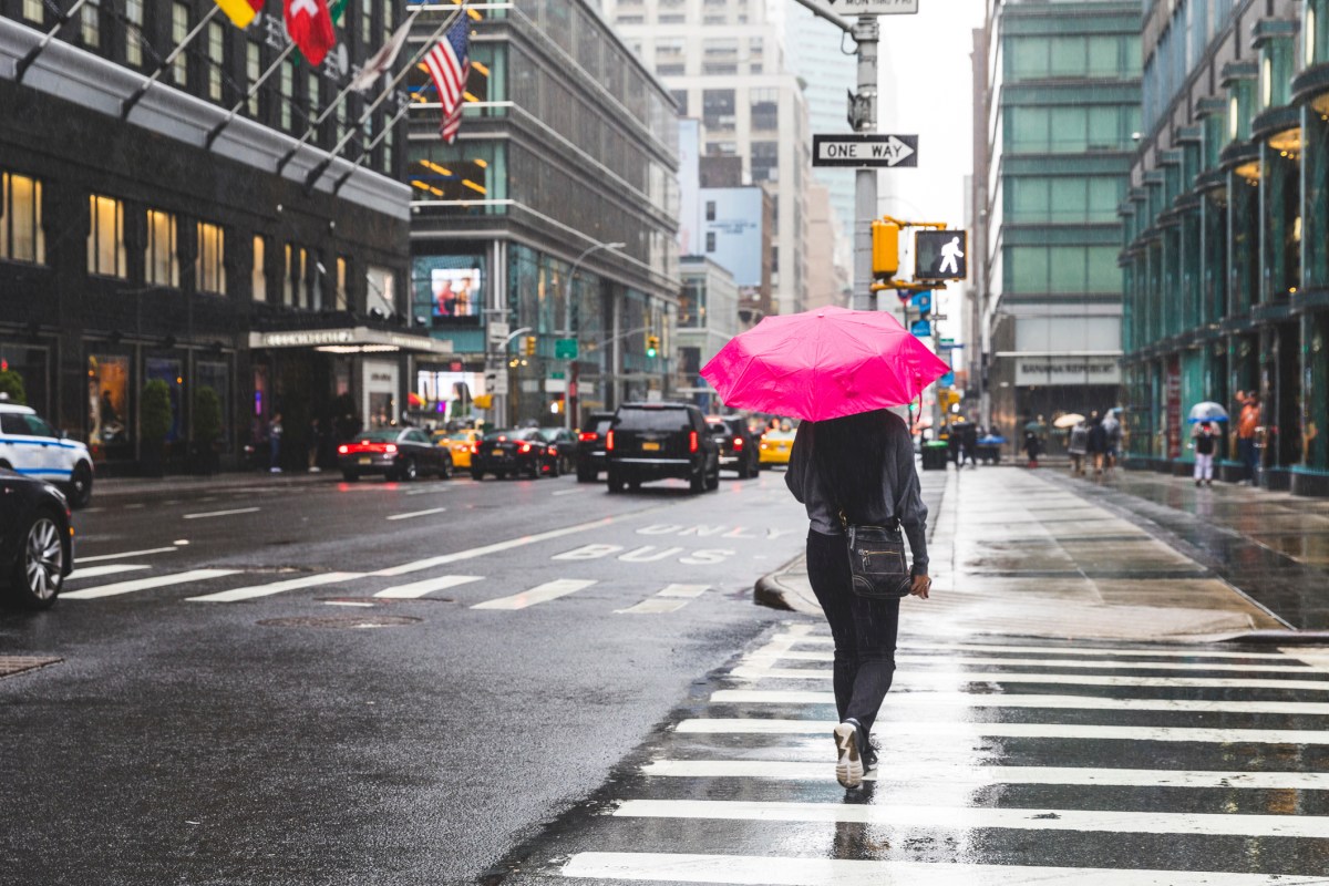 USA, New York, woman in the city on a rainy day