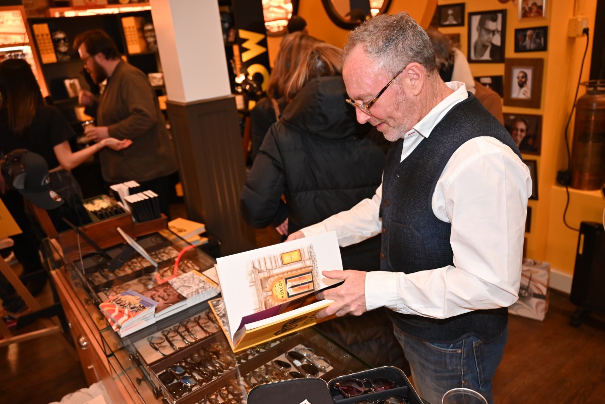 Harvey Moscot looking through his new book