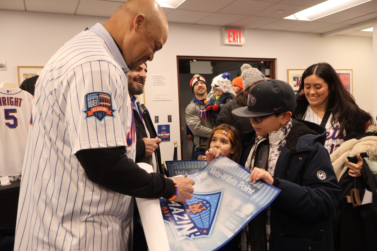 Butch Huskey signs a poster for a fan.