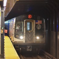 R train pulling into station in NYC transit system