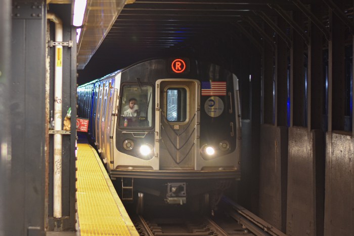 R train pulling into station in NYC transit system