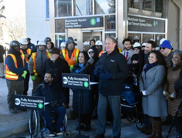 a group of people outside a Bronx subway station that was remodeled