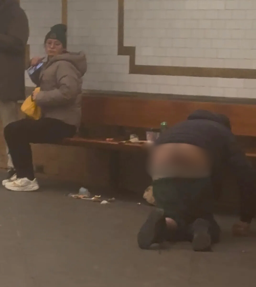 NYC subway rider looking at mentally disturbed man with pants down and bare buttocks exposed