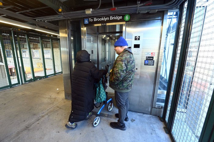 people going into a Bronx subway station elevator