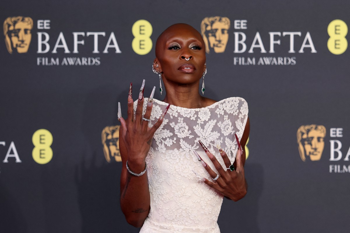 Cynthia Erivo attending red carpet with white dress and long nails.