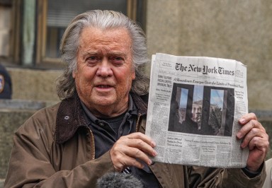 Steve Bannon holding up newspaper