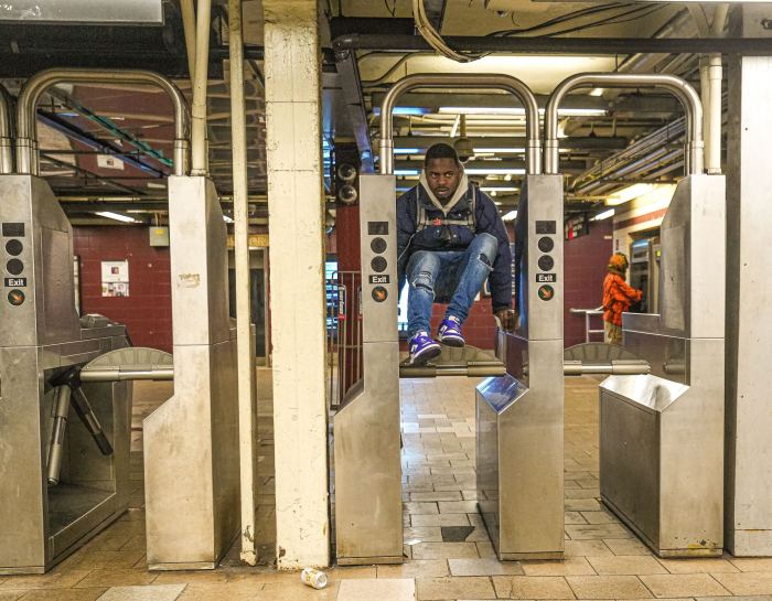 person hopping a turnstile