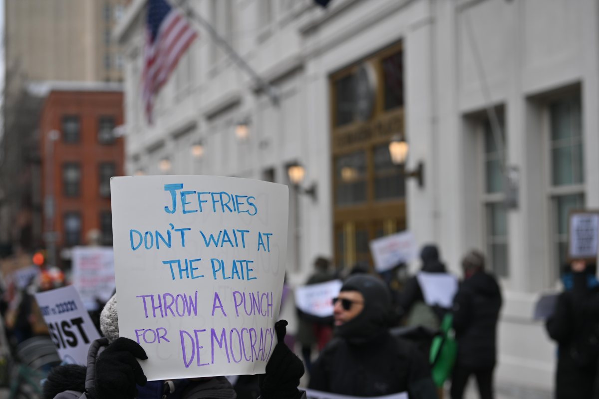 Protestors protest in front of Hakeem Jeffries' office denouncing President Trump, Elon Musk and calling for a removal of Mayor Eric Adams.