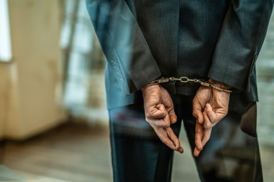 Man with handcuffs on during bail reform era