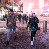 People walking through a snowy Times Square