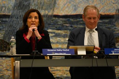 woman and man at a table talking about congestion pricing