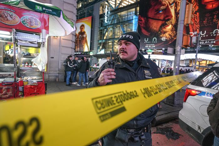 Police officer in Times Square investigating arson attack