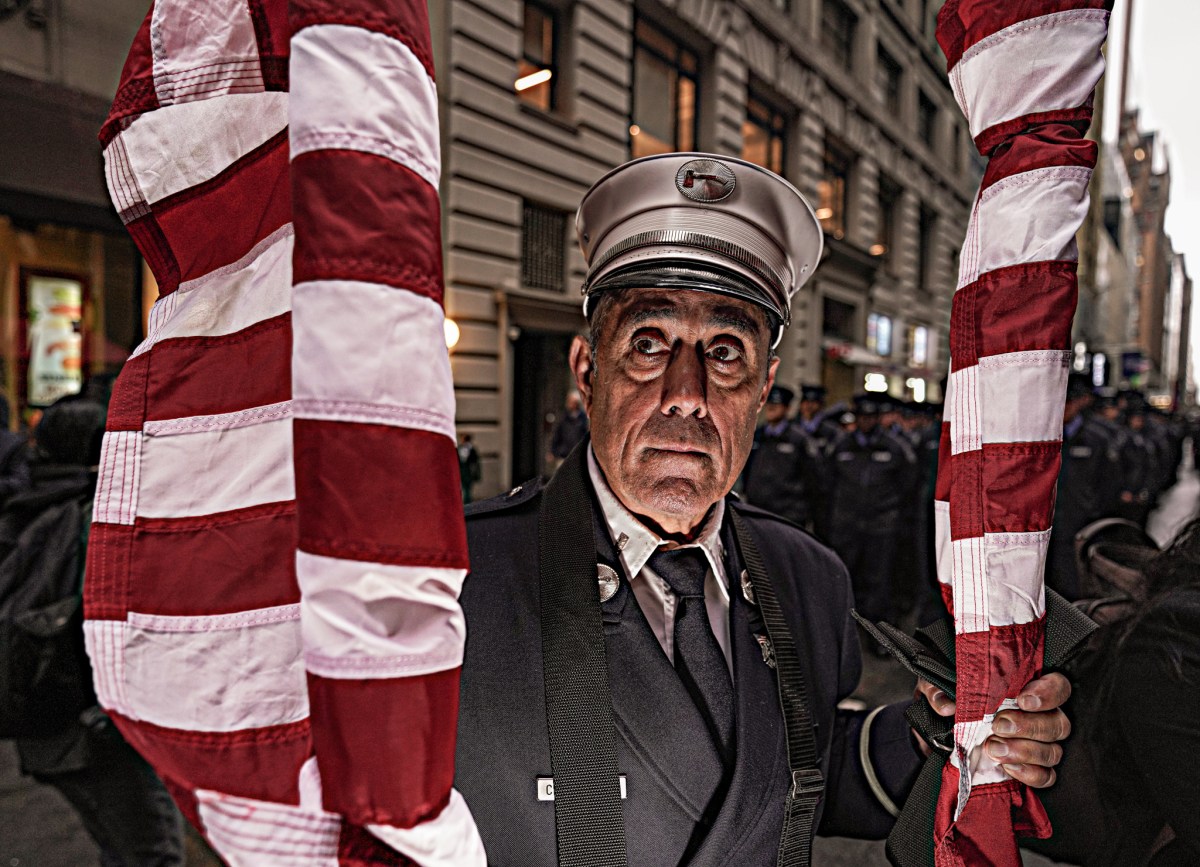 FDNY captain with American flags ahead of St. Patrick's Day parade