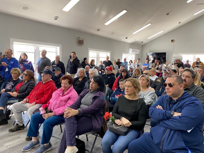 hundreds of people in a meeting room on Staten Island 