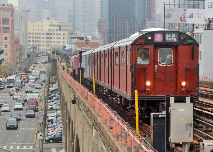 red-colored vintage train riding on tracks