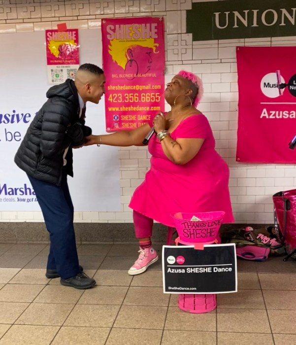 woman wearing pink greets a man in the Union Square subway station, one of many NYC transit hubs