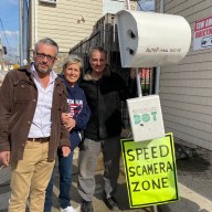 three people outside a house on Staten Island