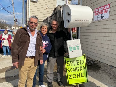 three people outside a house on Staten Island