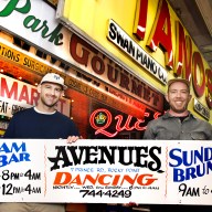 New York Sign Museum creators holding a vintage sign