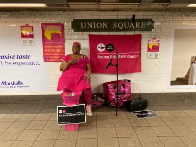 woman wearing hot pink in Union Square subway station, one of many NYC subways