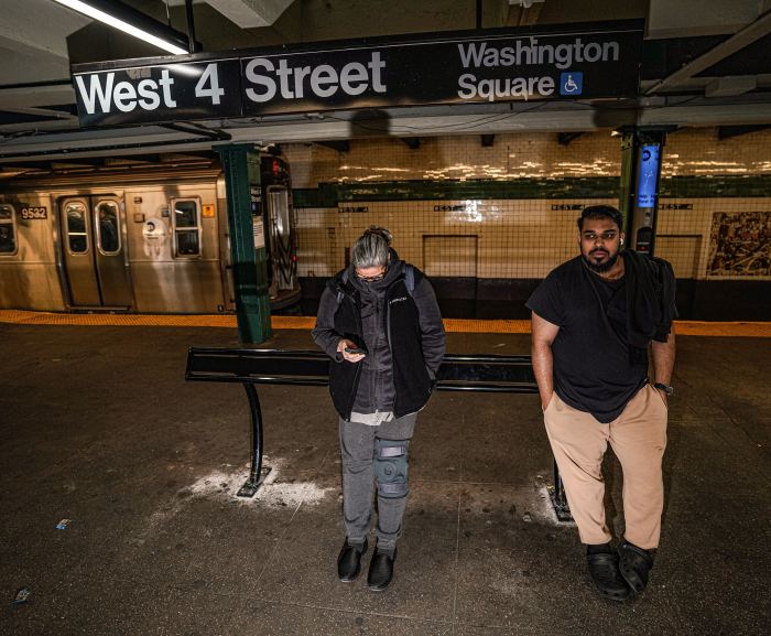 People waiting for a train inside a subway station